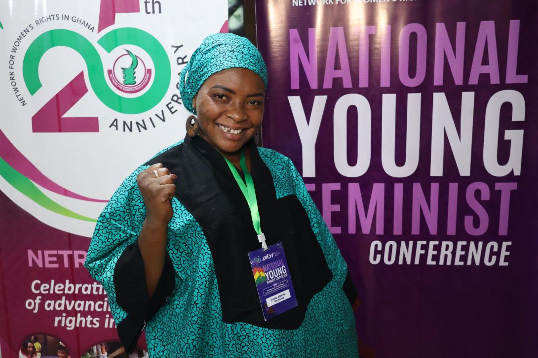  Avoka Alberta Wuntima appears in front of NETRIGHT pull up banners with a fist held high in excitement