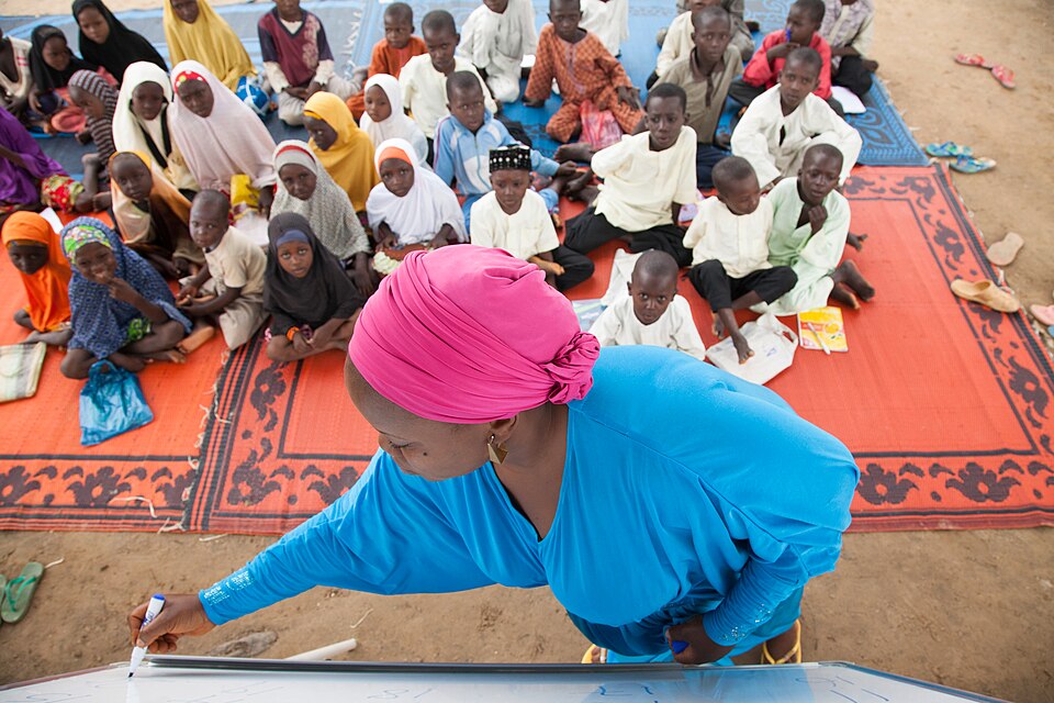 A volunteer teaches children in Nigeria. Photo: USAID